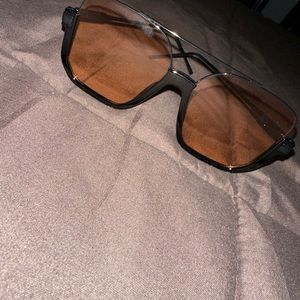 Two pair of sunglasses and one pair of non prescription eye glasses.